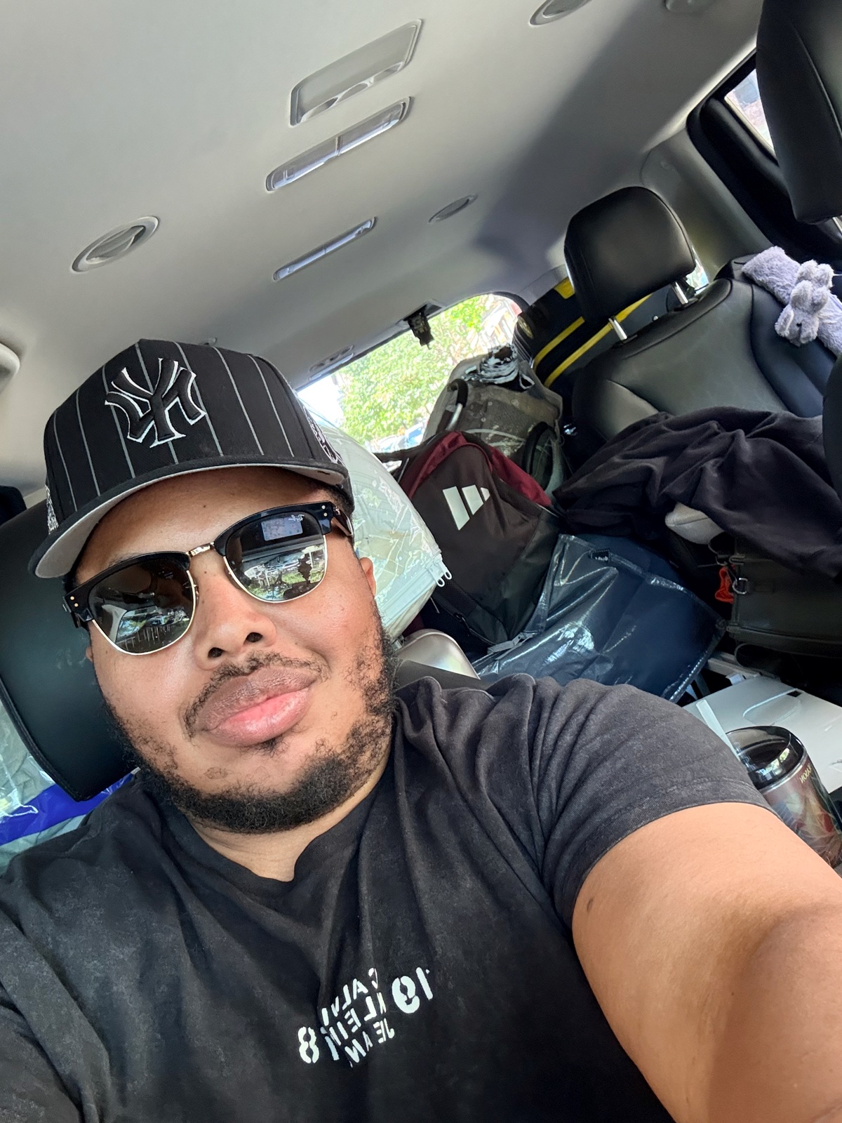 The driver's seat, sunglasses on, a truck packed to the roof with a teenager's whole life